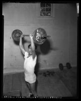 Bantamweight boxer Frankie Campos lifting weights in Los Angeles, Calif., circa 1953