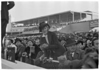 Spectators watch a race on opening day of Santa Anita's fourth horse racing season, Arcadia, December 25, 1937