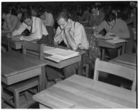 Candidates for police and deputy sheriff positions taking a written examination in City Hall, Los Angeles, March 2, 1940