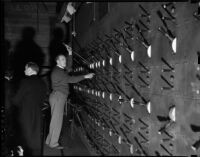 Member of the stage crew manages the lighting in Shrine Auditorium on opening night of the opera, Los Angeles, November 15, 1937