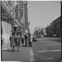 Woman and man talking to truant teenagers downtown, Los Angeles, March 1946