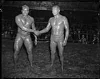 Sandor Szabo and Prince Bhu Pinder shaking hands in the ring after their mud wrestling match at Olympic Auditorium, Los Angeles, October 20, 1937