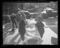 Choreographer and film director Busby Berkeley being carried into his manslaughter trial on a stretcher in Los Angeles, Calif., 1935