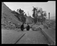 Two men stand near a crack that widened into a landslide in Elysian Park, Los Angeles, November 1937