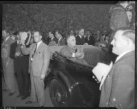 President Franklin D. Roosevelt with hat over heart in back of open air car, Los Angeles, October 1, 1935