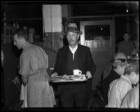 Man with a full dinner tray at the Midnight Mission on Thanksgiving Day, Los Angeles, November 25, 1937