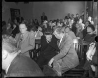 Louis Rude Payne, with father Lucius Payne at his side, at his inquest for the murder of his mother and brother. June 6, 1934