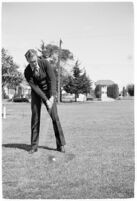 LA Daily News city editor Charles Judson demonstrates improper golf swings for a tutorial series with golfer Fay Coleman. Circa 1940