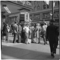 Woman talks to truant girls standing outside a downtown drug store, Los Angeles, March 1946