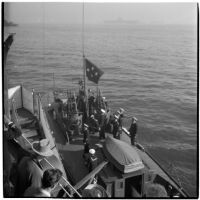 Naval officers perform a changing of the flags ceremony aboard the U.S.S. South Dakota to signal the retirement of Admiral William F. Halsey, Los Angeles, 1945