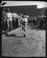 Jesse Owens sprints through a crowd of spectators, Los Angeles, 1930s