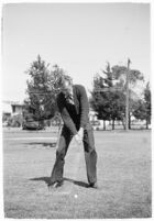 LA Daily News city editor Charles Judson demonstrates improper golf swings for a tutorial series with golfer Fay Coleman. Circa 1940