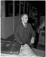 Physical oceanographer Dr. George McEwan of Scripps Institute of Oceanography sits at desk, Los Angeles, 1930