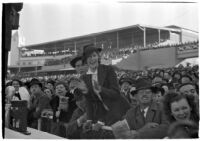 Spectators watch a race on opening day of Santa Anita's fourth horse racing season, Arcadia, December 25, 1937