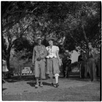 Buck Reisinger and Alice Wisser walking arm-in-arm during Anaheim's annual Halloween festival, Anaheim, October 31, 1946