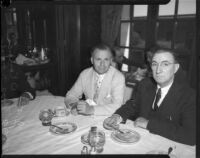 Judge James Francis Thaddeus O'Connor and congressman Thomas Francis Ford sit and eat pie at table, Los Angeles, 1930s