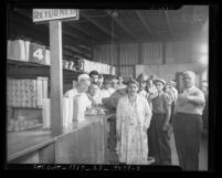 People lined up at counter of Los Angeles County Welfare Food Exchange, circa 1934