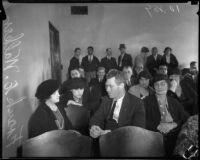 Frank E. Walker, father of murder victim Frances Walker, sits in a crowded room, Los Angeles, 1935