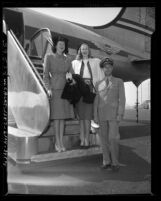 Three members of the California Tip Toppers club for tall men and women arriving for first national convention in Los Angeles, Calif., 1947