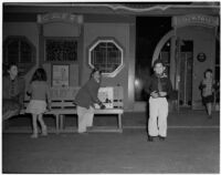 Children play near a bench and restaurant in Chinatown, Los Angeles, 1930s