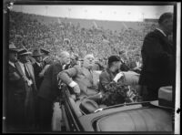 President Franklin D. Roosevelt, accompanied by Eleanor Roosevelt, about to address the crowd at Los Angeles Memorial Coliseum from car, October 1, 1935