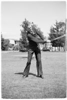 LA Daily News city editor Charles Judson demonstrates improper golf swings for a tutorial series with golfer Fay Coleman. Circa 1940