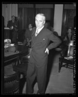 Charlie Chaplin standing in Los Angeles courtroom during 1945 paternity trial