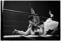 Heavyweight wrestler El Pulpo grappling with an opponent at the Olympic Auditorium, Los Angeles, 1937