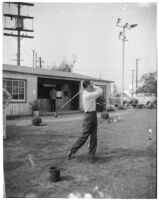 Blind veteran hitting a bucket of golf balls, Los Angeles, 1940s