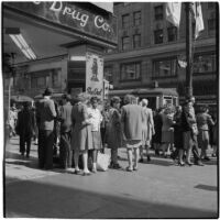 Woman talks to truant girls standing outside a downtown drug store, Los Angeles, March 1946