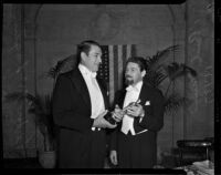 Actors Paul Muni and Victor McLaglen holding an Oscar at the Academy Awards, Los Angeles, 1937