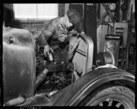 Man works on a tractor engine at the Unemployed Citizens' League of Santa Monica, 1930s