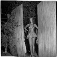 Model wears a sparkly "cover-up" swim suit design by Margit Fellegi during a fashion show, Los Angeles, September 1946