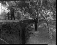 Officials survey a crack that would become a landslide in Elysian Park, Los Angeles, November 1937