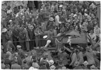 Damaged car in the midst of the Mystic Shrine's Durbar festival, Los Angeles