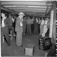 Tony Cornero surrounded by staff on his newly refurbished gambling ship, the Bunker Hill or Lux, Los Angeles, 1946