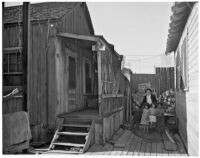 Woman stands with four children in the slums, Los Angeles, 1925-1945