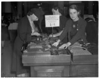 Three women getting a deal on socks during the semiannual Dollar Day sale in downtown Los Angeles, February 17, 1940