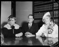 Evangelist Aimee Semple McPherson with her nurse Ella Nordin and her business manager Giles Knight in her attorney's office, Los Angeles, 1937