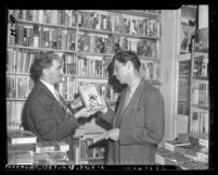 Reporter Vern Partlow and Joseph Epstein looking at "Canterbury Tales" book, deemed obscene, circa 1946