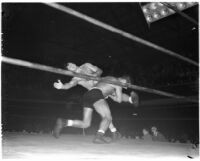 Gino Garibaldi tackles La Verne Baxter during a wrestling match at Olympic Auditorium, Los Angeles, September 22, 1937