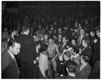 Hungarian wrestler Sandor Szabo walking through the crowd before a match against George Zaharias, Los Angeles, 1930s