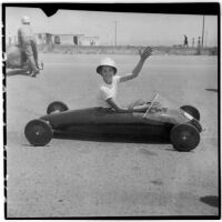 Al Pedrosa waving from his soap box derby car, Los Angeles, 1946