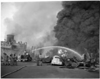 Fire fighters hose down one of many fires that raged after the Markay oil tanker exploded in L.A. Harbor, Los Angeles, 1947