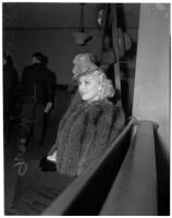 Mae West sitting in court during questioning about earnings from her role in the movie "She Done Him Wrong," Los Angeles, 1940