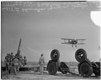 Observation squadron aims anti-aircraft gun at a Douglas plane during a military show for National Defense Week, Los Angeles, 1940