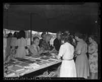 Women browsing book table at the 1946 Seventh Day Adventists camp meeting in Lynwood, Calif