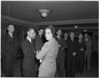 Ruth Jackson, director at The Kern Ridge Oil Company, with a group of unidentified men, Los Angeles, 1941