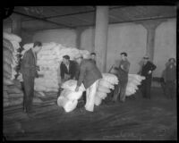 Unidentified men unload bags of Daisy flour, Los Angeles, 1930s