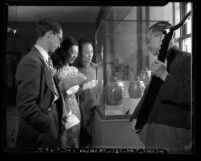 Henry Trubner, Los Angeles County Art Museum curator of Oriental art viewing exhibit with Pauline Wong and Hung-Pin Kwan, circa 1947